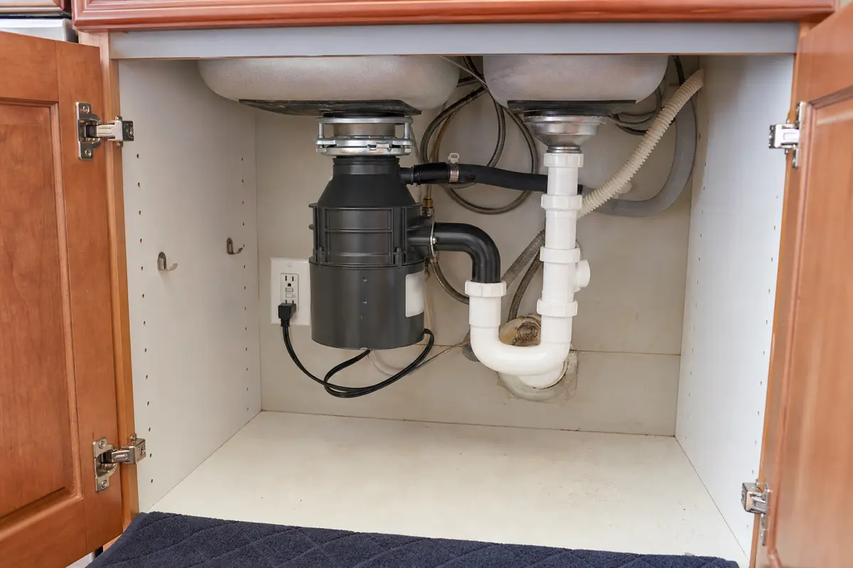 Frigidaire garbage disposal under sink while checking GFCI trip clues