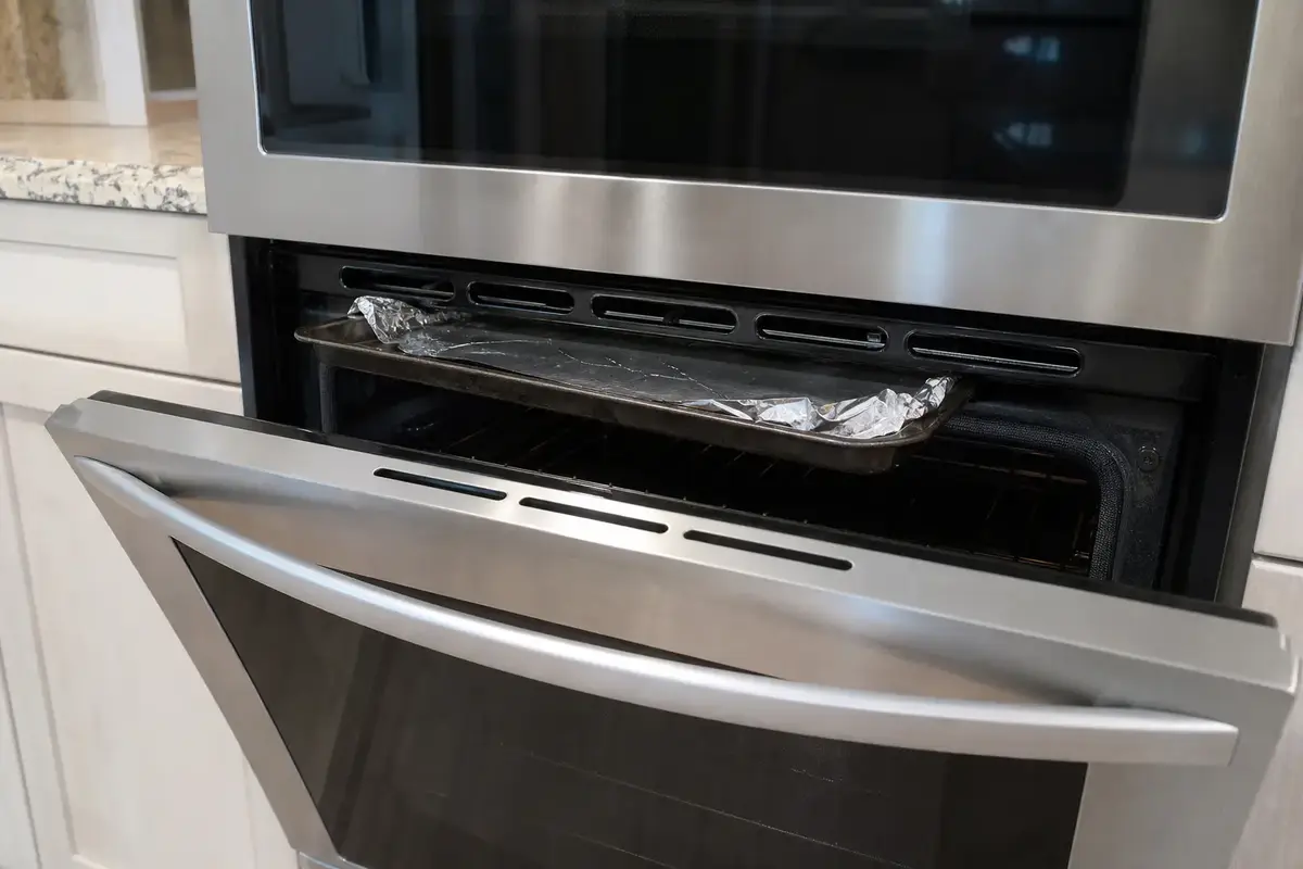Baking sheet and foil sitting too close to a GE Profile style oven vent path