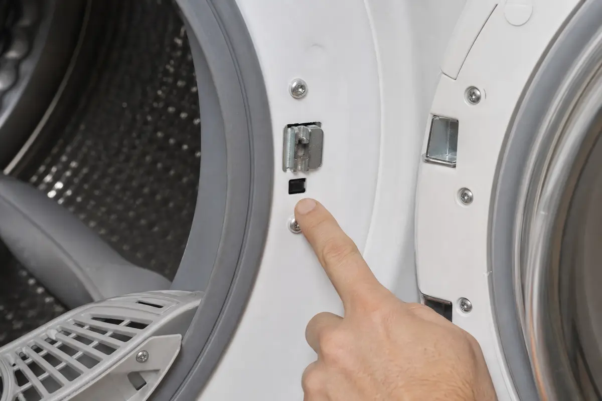 LG-style dryer door latch and switch area inspected for an immediate stop after Start