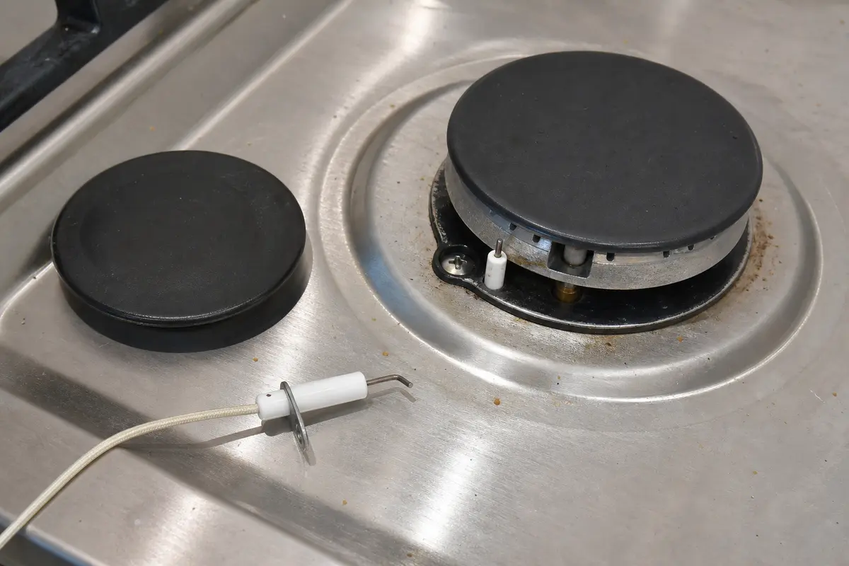 Gas cooktop spark igniter close-up for LG burner won't ignite