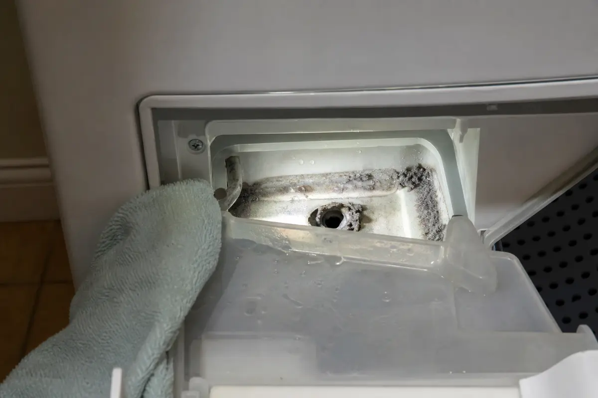 Miele dryer water container seat with lint sludge blocking the condensate drain opening