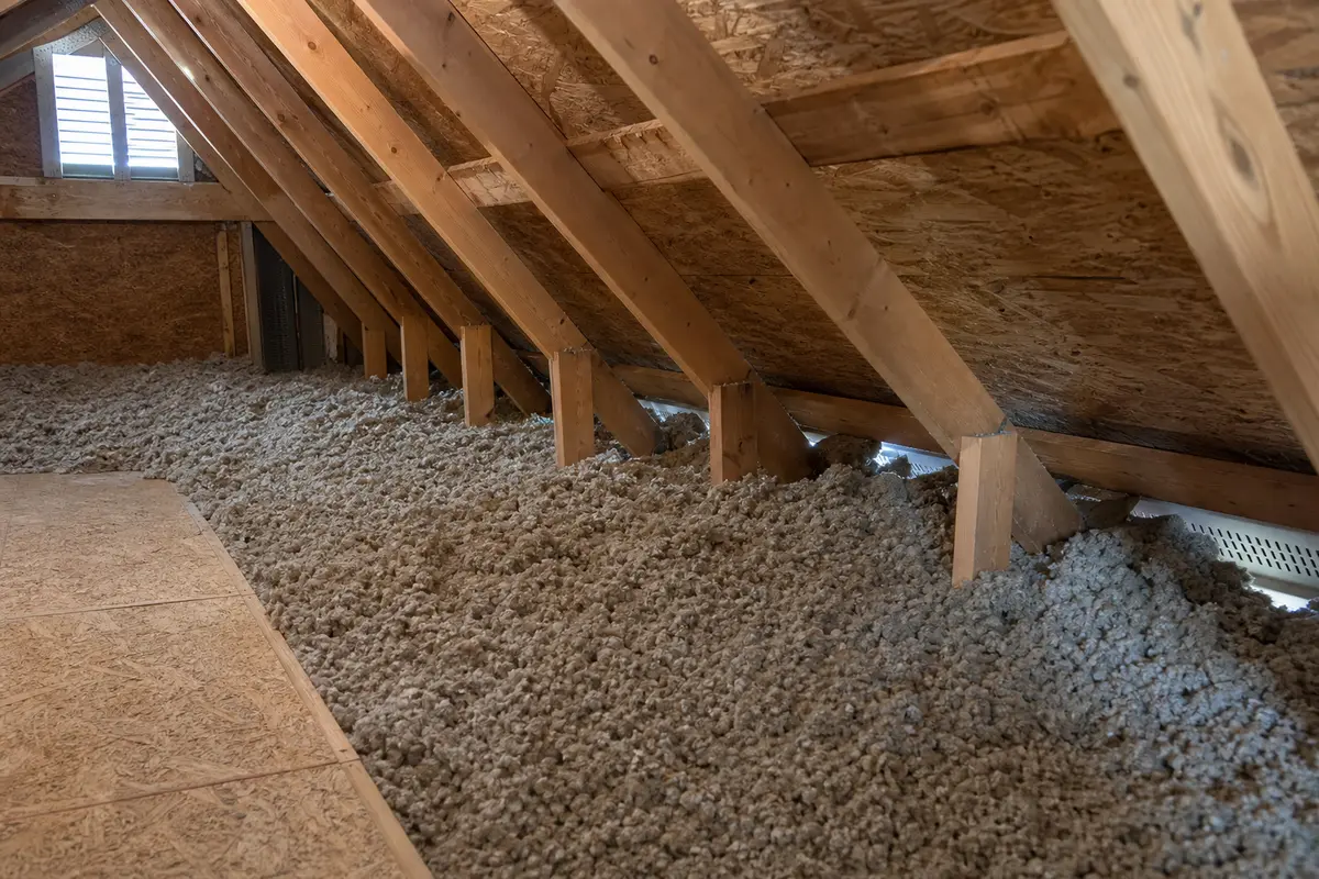 Attic eave area checked for blocked soffit intake before ventilation repairs