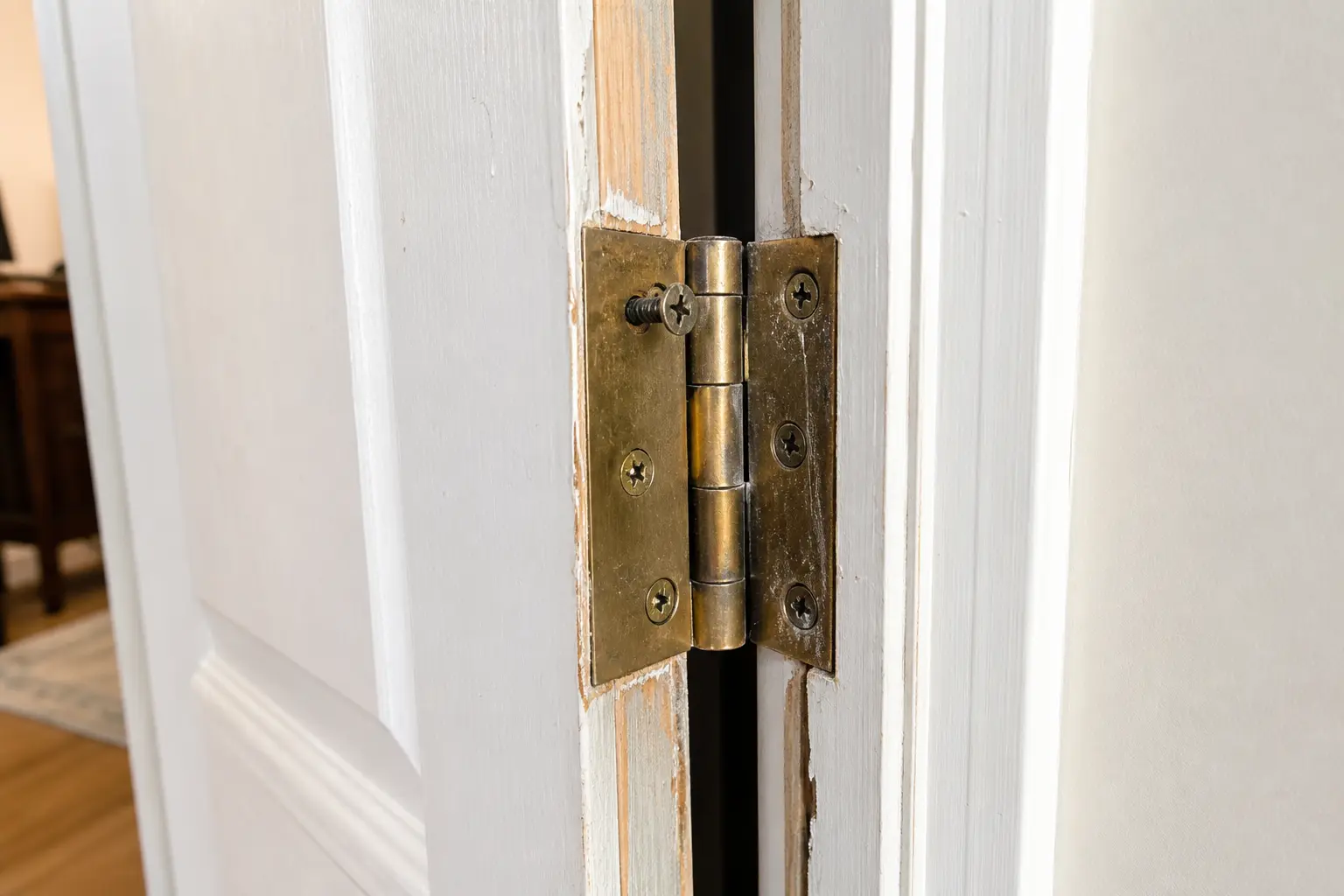 Loose top hinge screws on door jamb causing door to rub at bottom