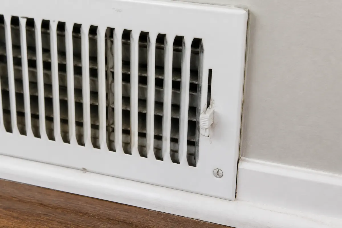 Close view of adjustable supply register damper that can chatter in airflow