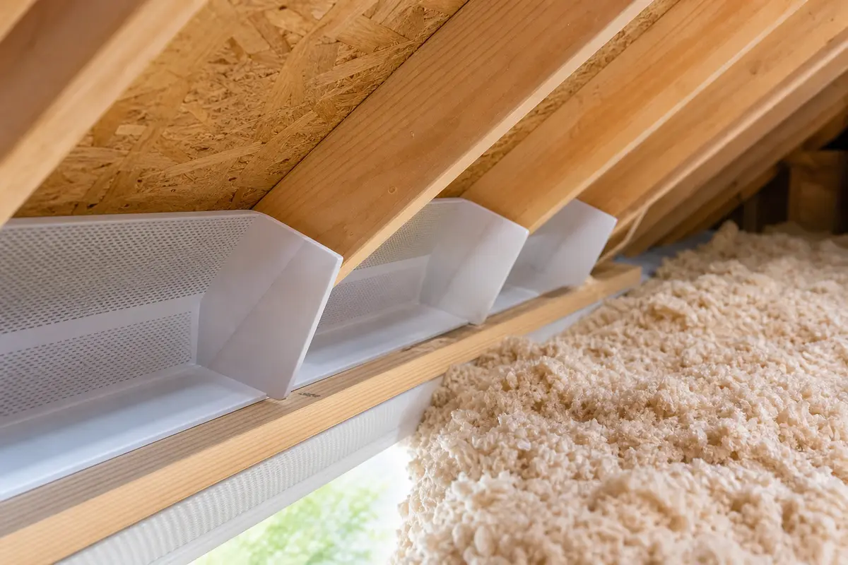 Attic ventilation baffle keeping soffit intake open near insulation