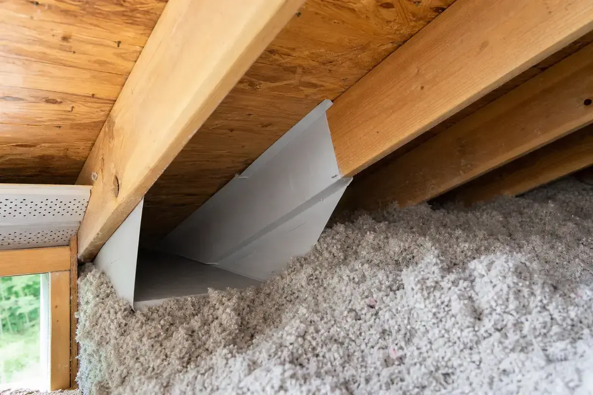 Attic ventilation baffle keeping soffit intake open in a hot attic