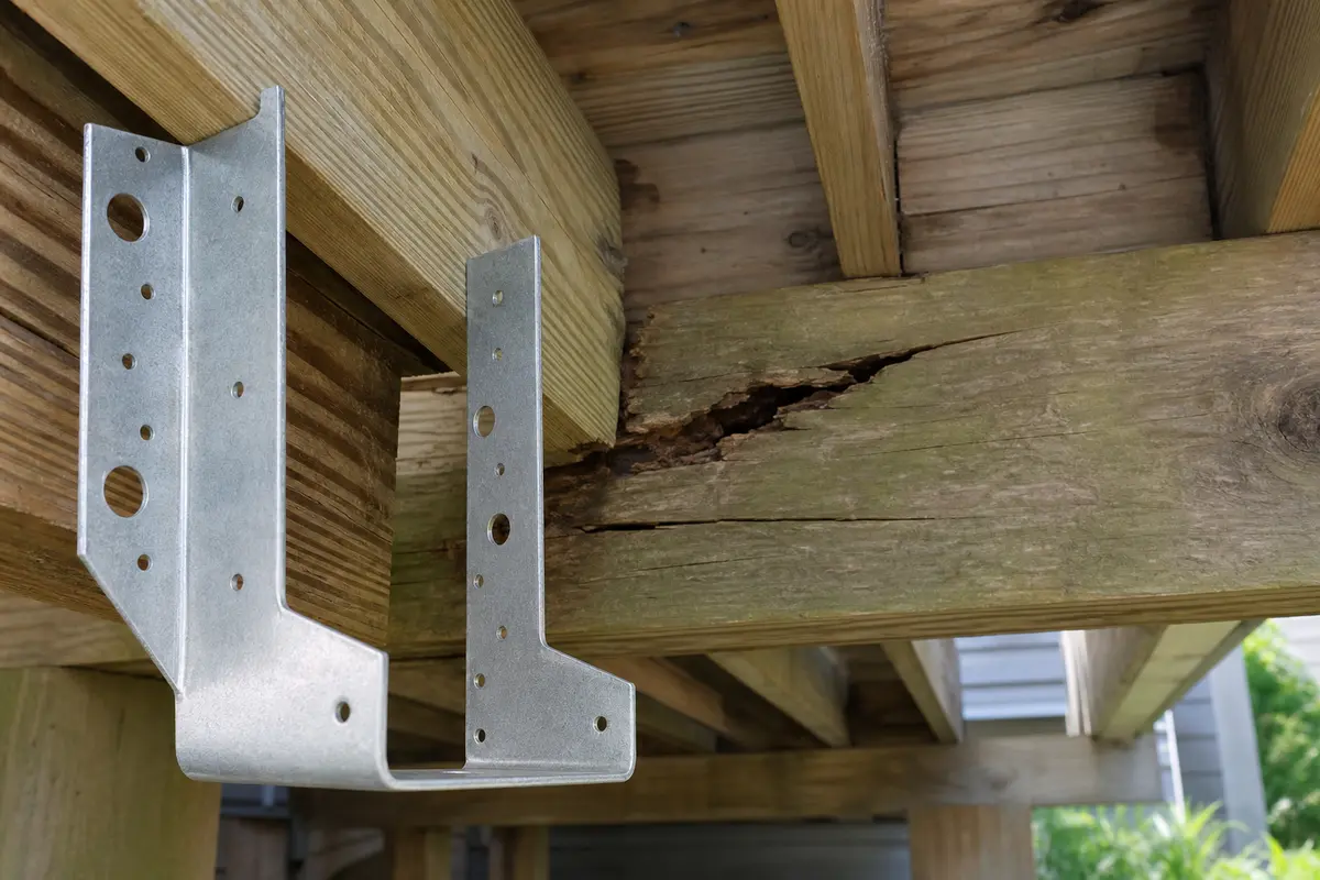 Galvanized joist hanger for deck beam cracked