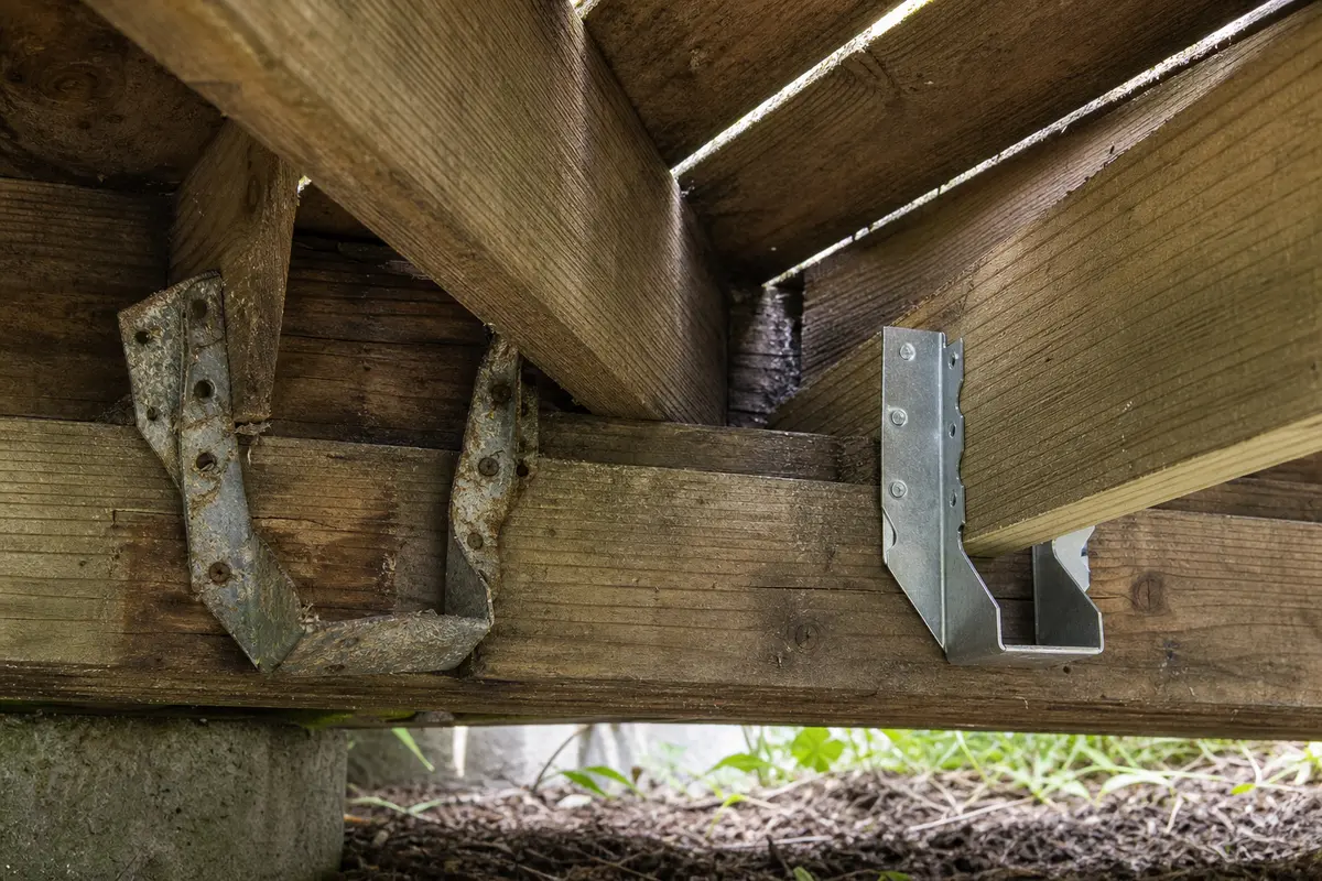 Galvanized joist hanger for a verified deck framing repair