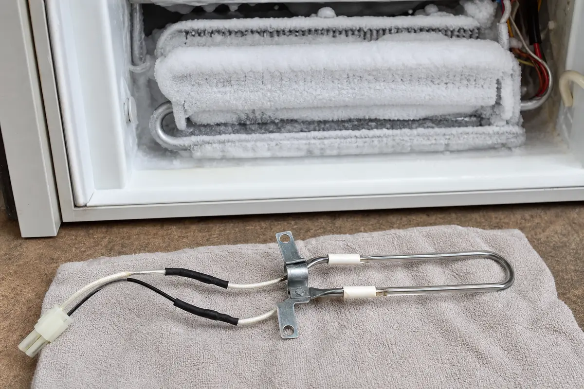 Refrigerator defrost heater checked after repeated evaporator frost buildup
