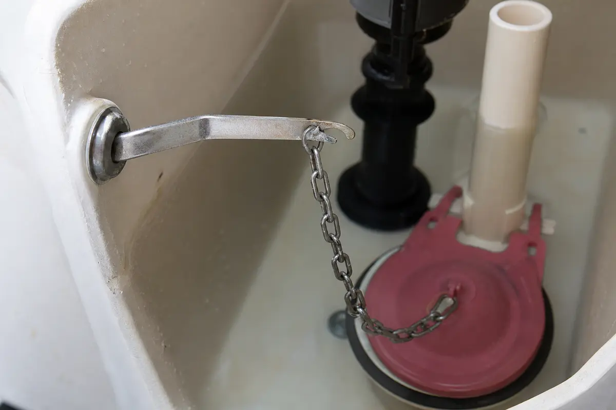 Toilet trip lever and chain connection checked when a toilet keeps running