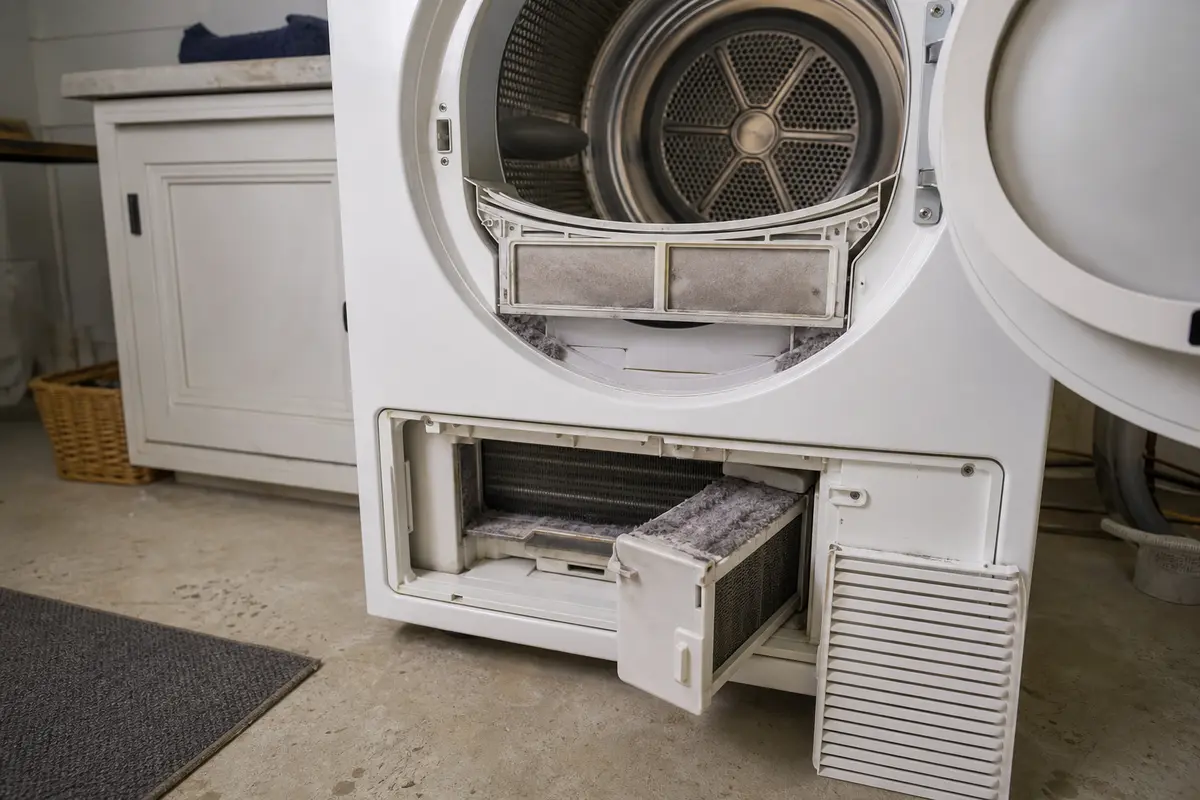 Miele-style front-load dryer with lint filter and lower airflow filter access open
