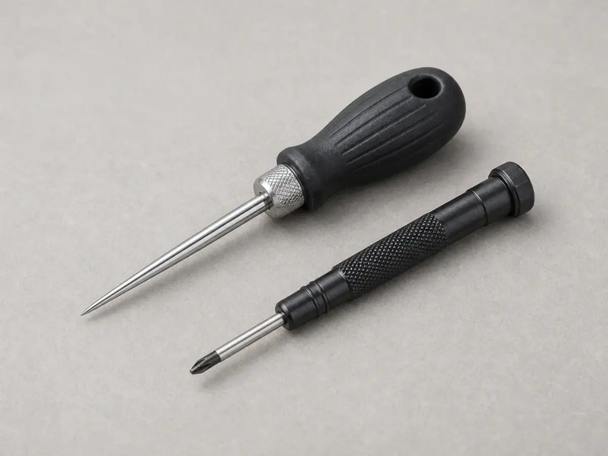 Awl and small screwdriver for probing carpenter bee holes in siding trim