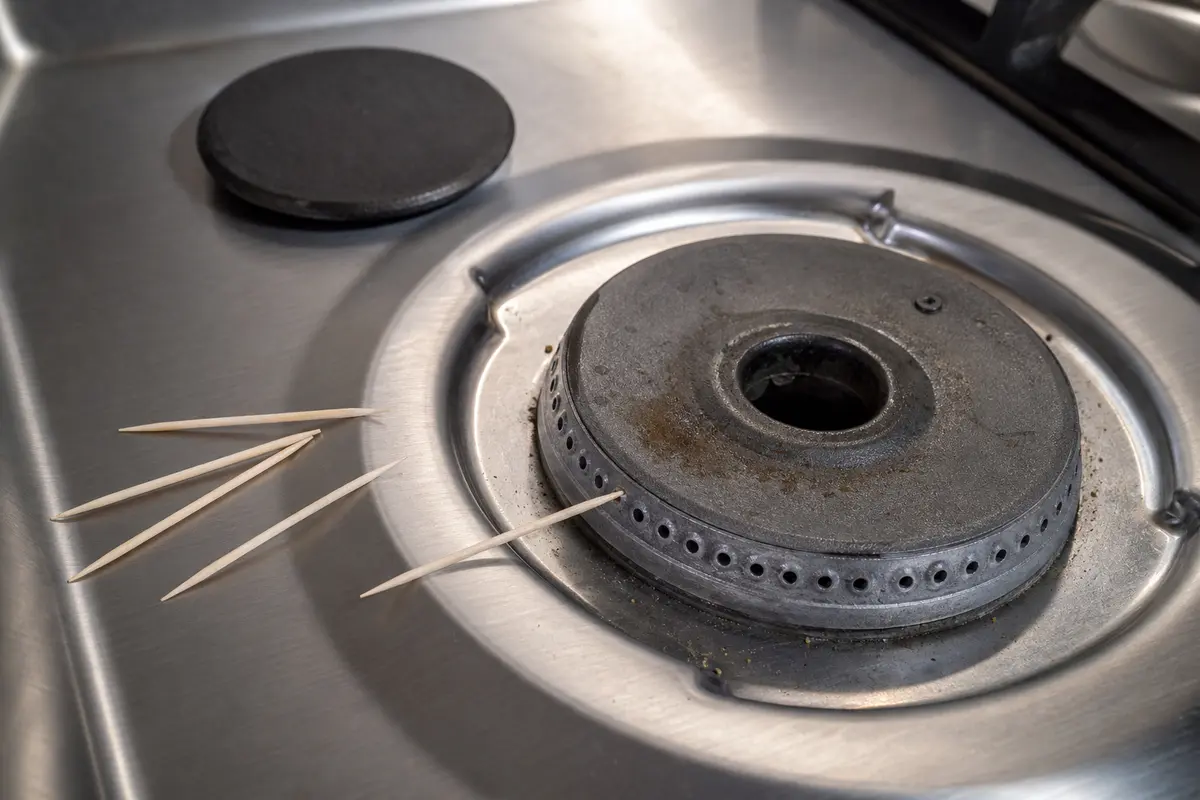 Nonmetal cleaning picks shown in the repair area for ge profile stove burner not heating