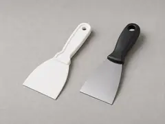 Plastic putty knife or gap scraper tool