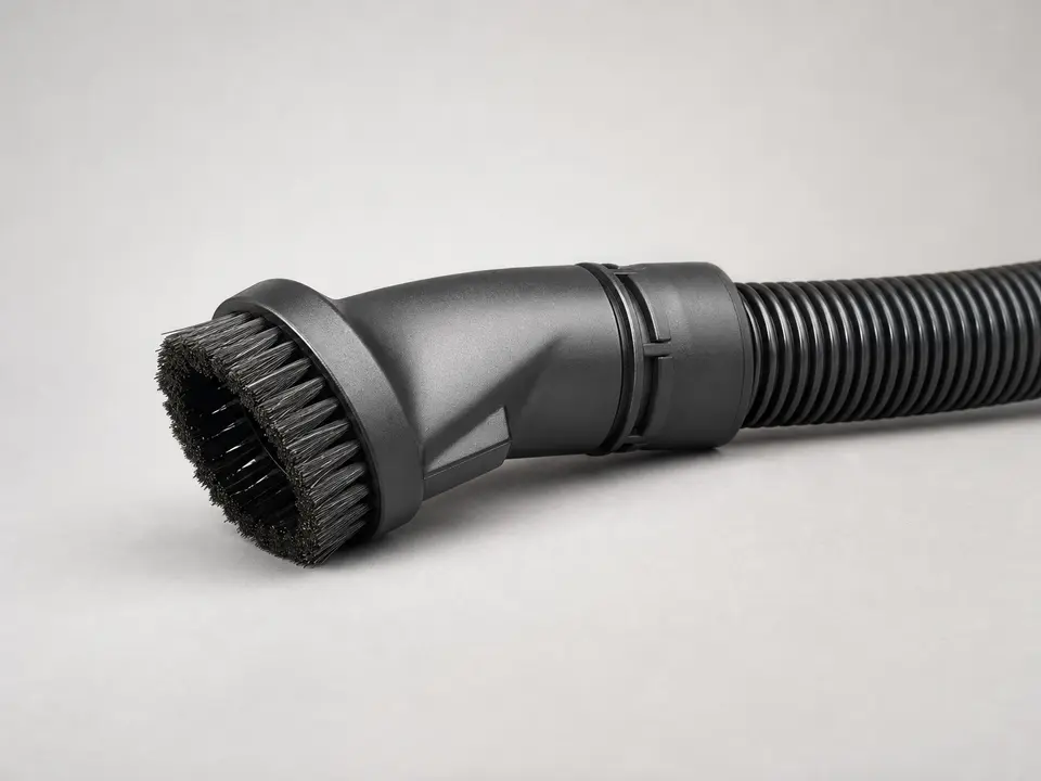 Vacuum brush attachment lifting dust from a reusable HRV or ERV filter